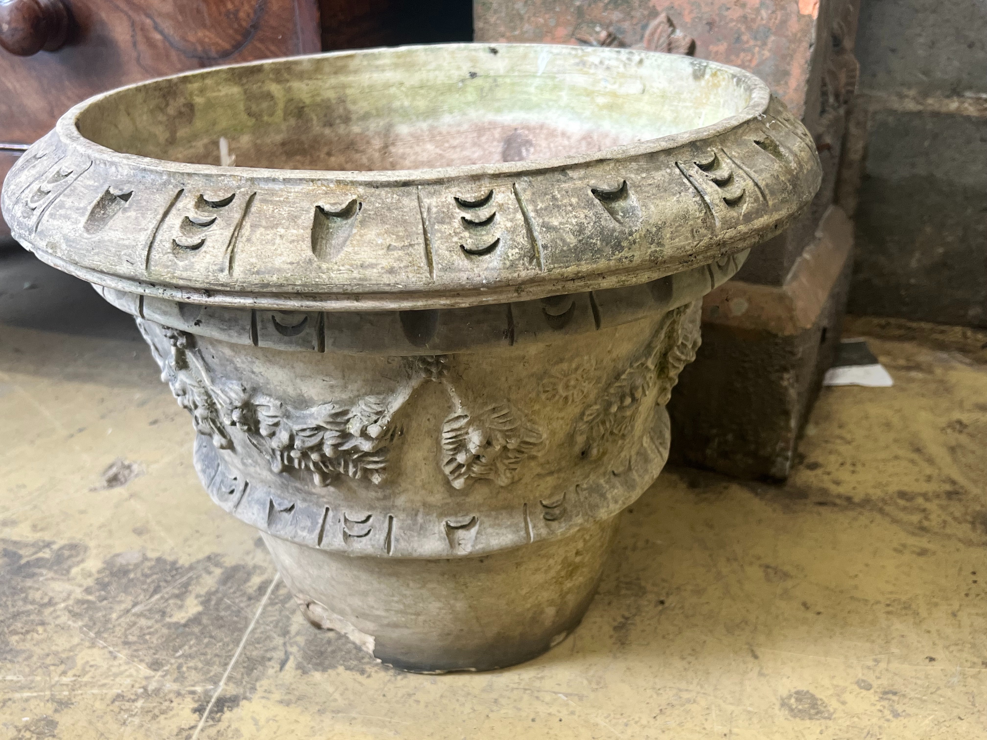 A terracotta campana garden urn on square plinth, height 77cm., together with a circular reconstituted stone garden planter